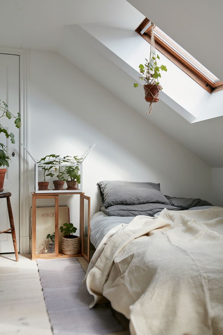 Attic bedroom in a Charming Plant-Filled Attic Apartment In Sweden - Gravity…