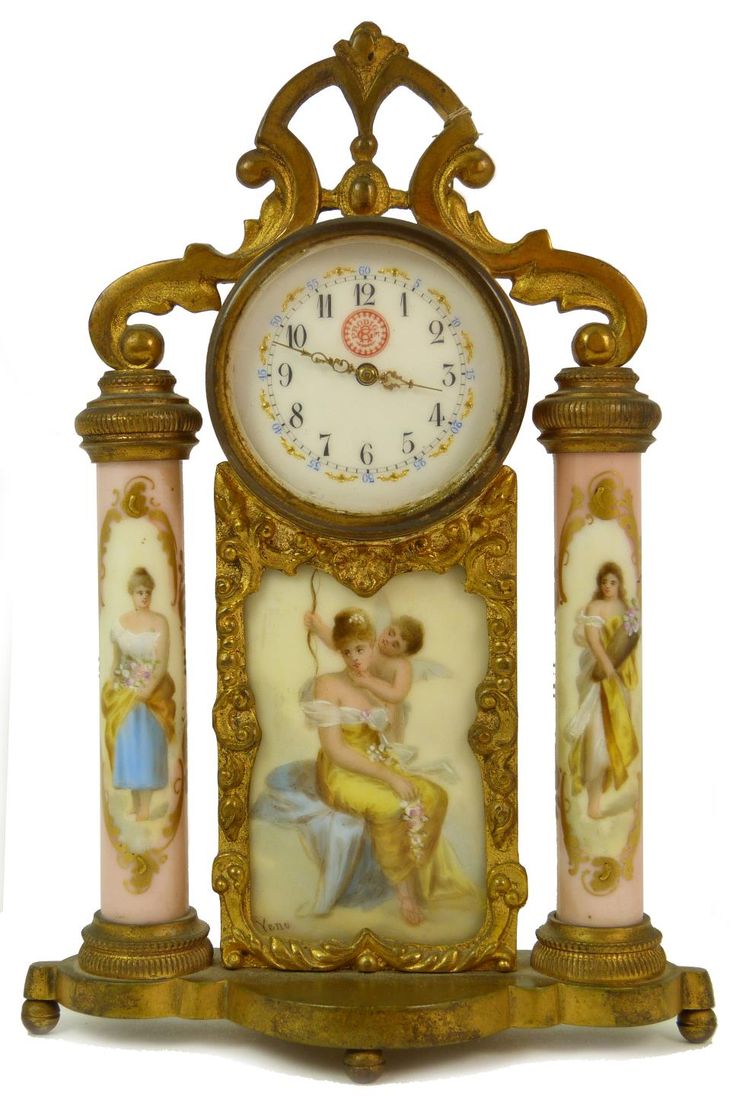 Antique Bronze Clock with columns. Clock depicts cherub with beautiful woman. Cl...