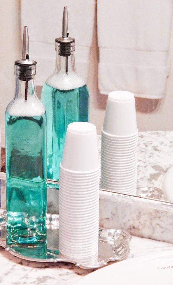 Put mouthwash in a container, with cups and on a cute tray for your bathroom sin...