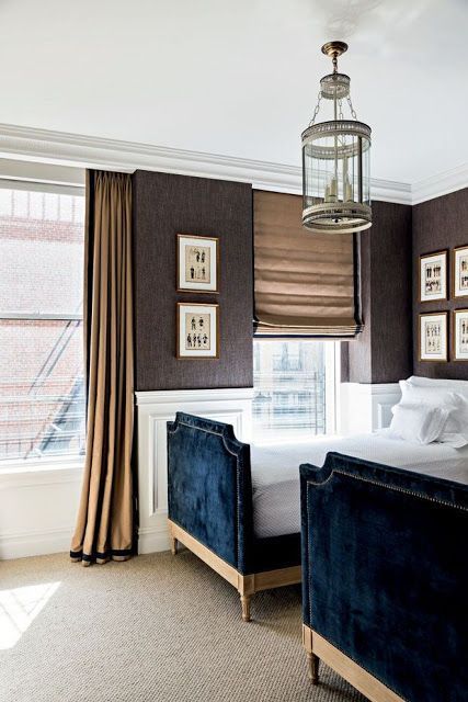 Chic, elegant boy's bedroom features a round lantern illuminating upper wall...