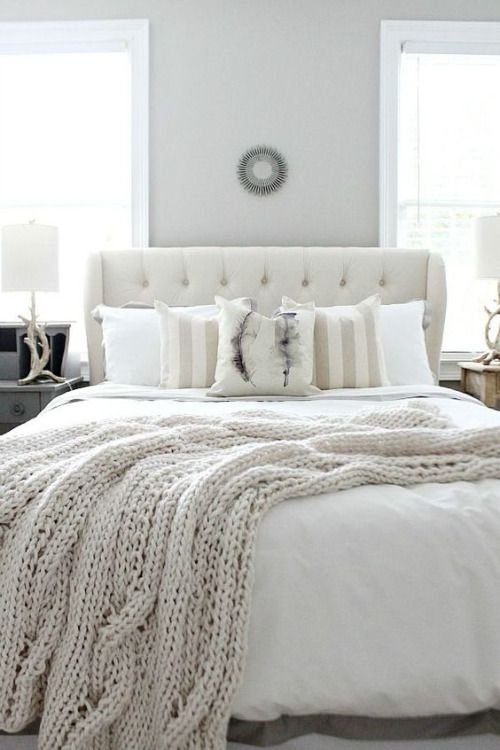 White bedroom and chunky knit cable throw.