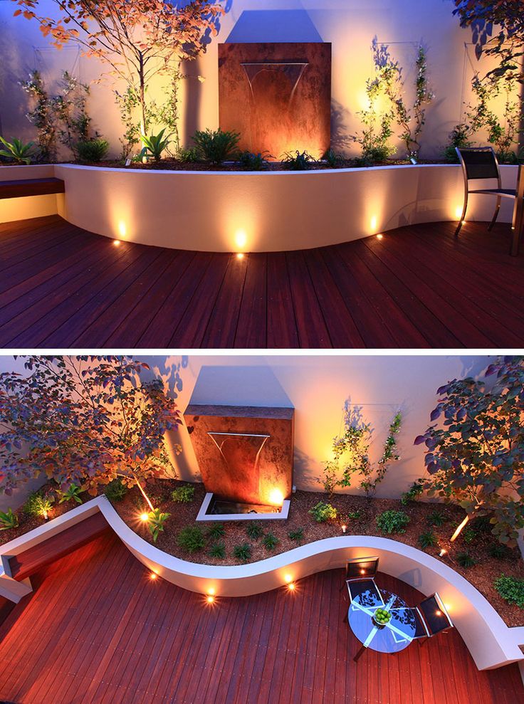 Recessed lighting on this curved patio and inside the planters brighten the outd...