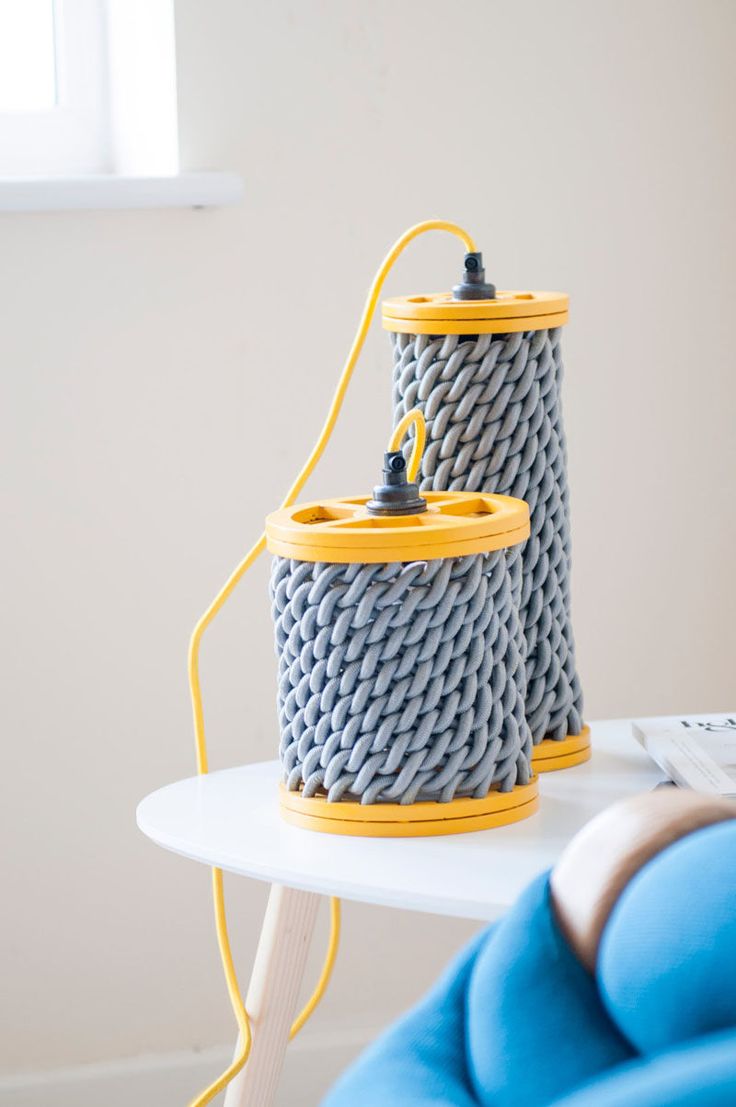 These creative yellow and grey pendant lights have woven elements.