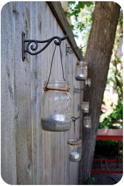 Outdoor lighting with mason jars. Kind of a cool idea. I think maybe even  paint...