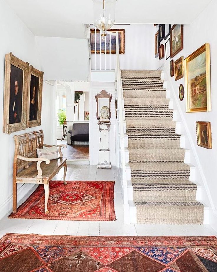 Loving this rustic vintage modern entryway. That runner on the stairs is amazing...