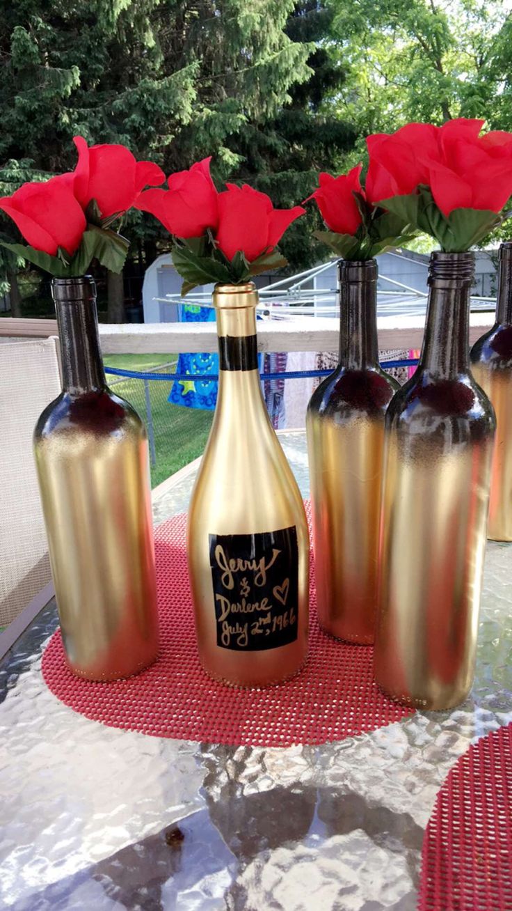 Black and gold ombre, spray painted wine bottles.  These were used as cake table...