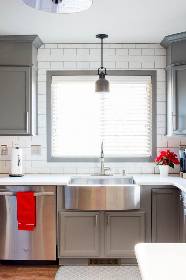 A builder grade kitchen gets a new look with classic features like gray cabinets...