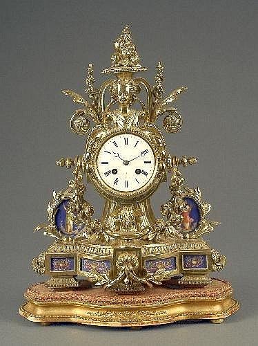 A French porcelain mounted gilt metal mantel clock, the circular white enamelled...