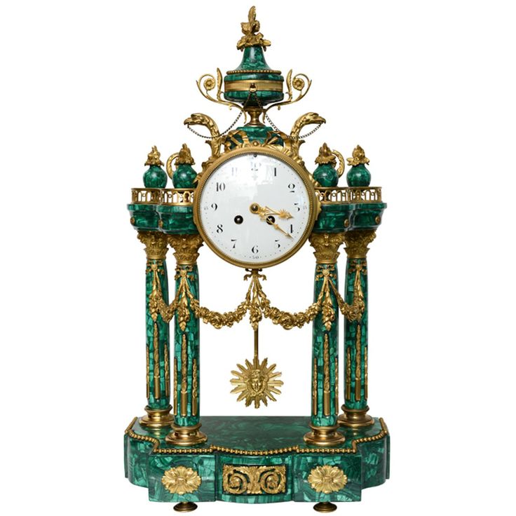 Neo-classic style ormolu and malachite mantel clock. Clock has an enamel face wi...