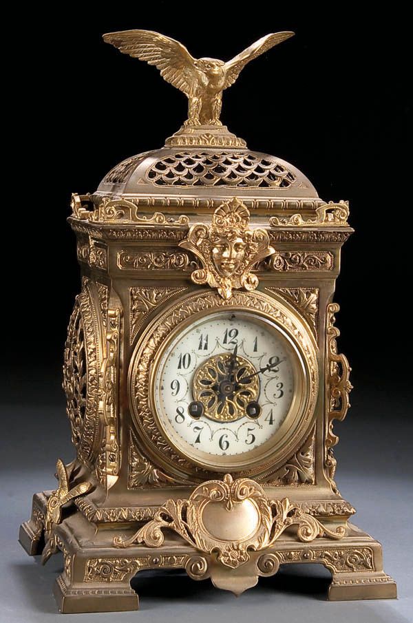 VICTORIAN GILT BRONZE SHELF CLOCK 19th century, with enameled chapter ring conta...