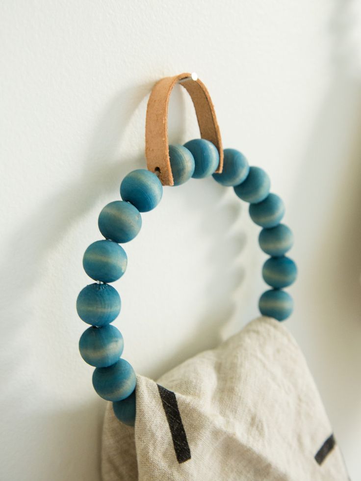 DIY Towel Ring with wood beads and a leather hanger.