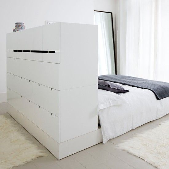 White bedroom with headboard cupboards