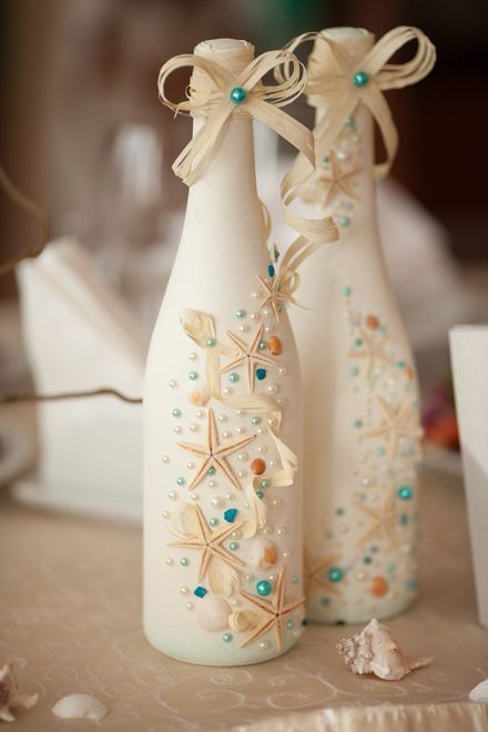 50 Inspiring Centrepieces; paint glass bottles and decorate them with shells...