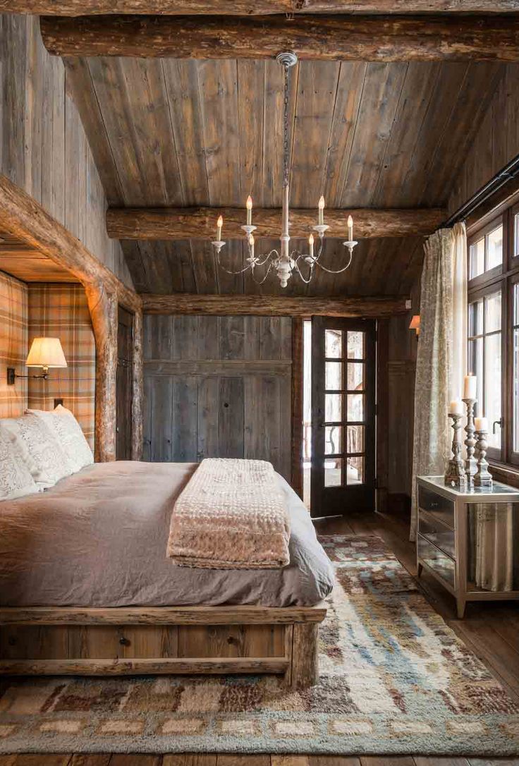 cabin/mountain home master bedroom with chandelier and tartan full height bed he...