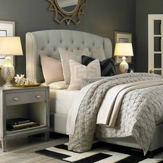 cozy bedroom with tufted upholstered bed, neutral light grey linens...