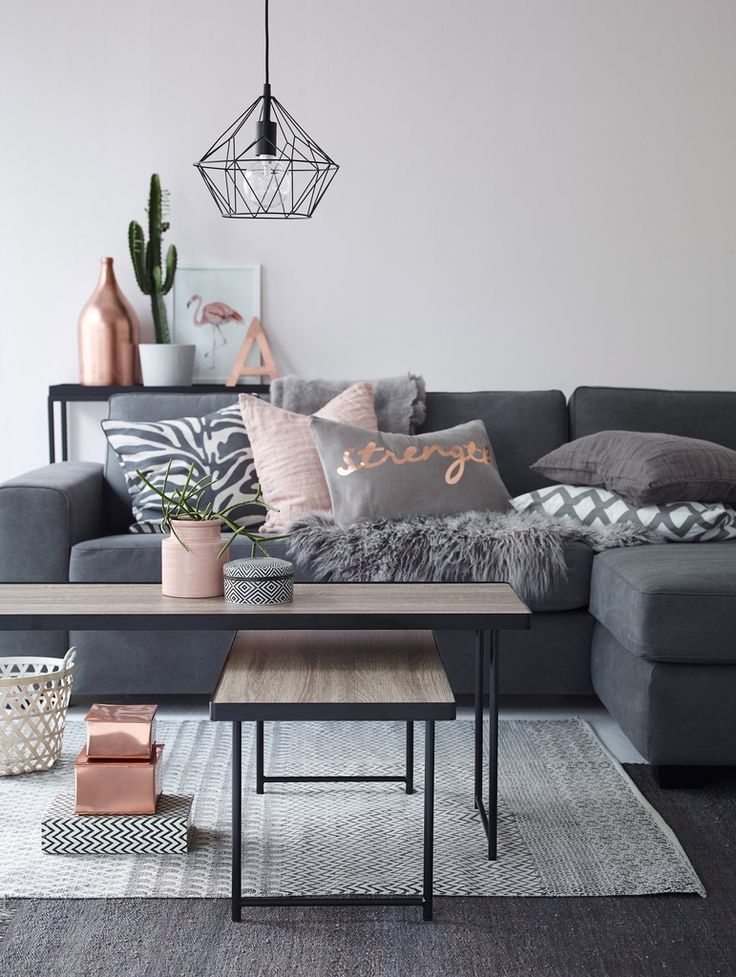 Modern living room in grey with copper and pink accents. Geometric diamond penda...