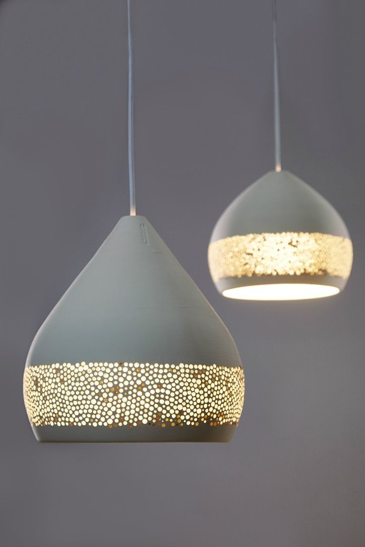 A Warm Glow Slips Through The Porous Skin Of These Ceramic Lampshades