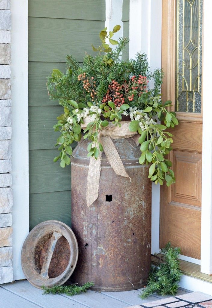 Old rusty milk jug turned into a planter.  Lovely, rustic outdoor decor!