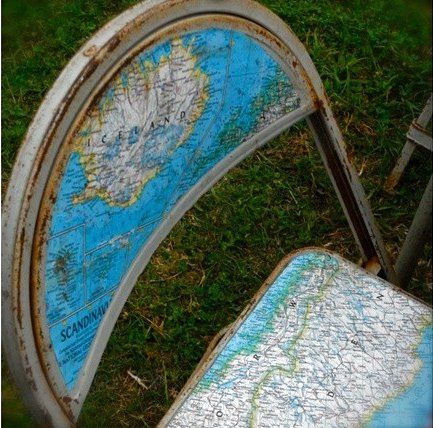 Decoupage maps onto worn out simple metal folding chairs