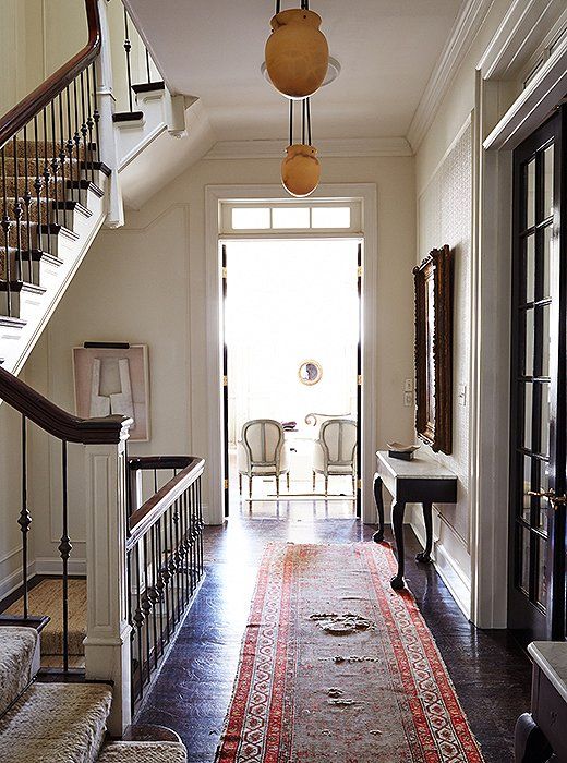 The airy second-floor landing, with its antique alabaster pendants and a gorgeou...
