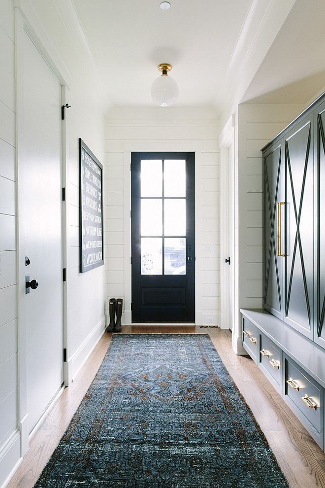 Transitional Mudroom with black door, charcoal cabinets and brass hardware. A vi...