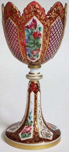 A 19th century Bohemian ruby glass chalice with white overlay and gilding with p...
