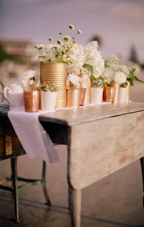 Add some rustic charm to your beach wedding with this DIY tin can project as see...