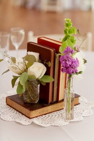 Check out this romantic idea to use vintage books alongside small bud vases!    ...