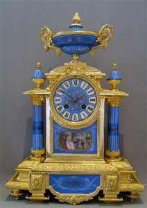 French antique clock set in porcelain and ormolu with silver