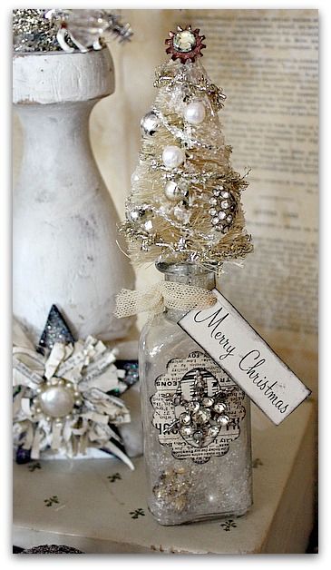 bottle brush tree on a bottle, fill with snow and pearls and metal stars.