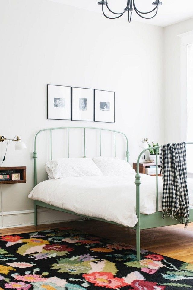 I love the green bed frame!  Feminine yet minimal bedroom with a floral area rug...