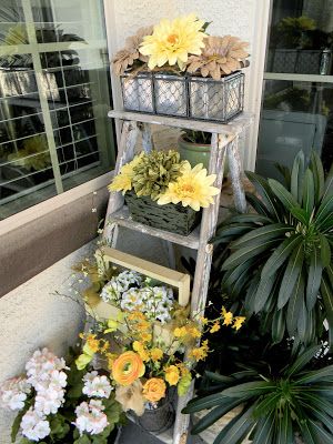 Display potted flowers on an old ladder
