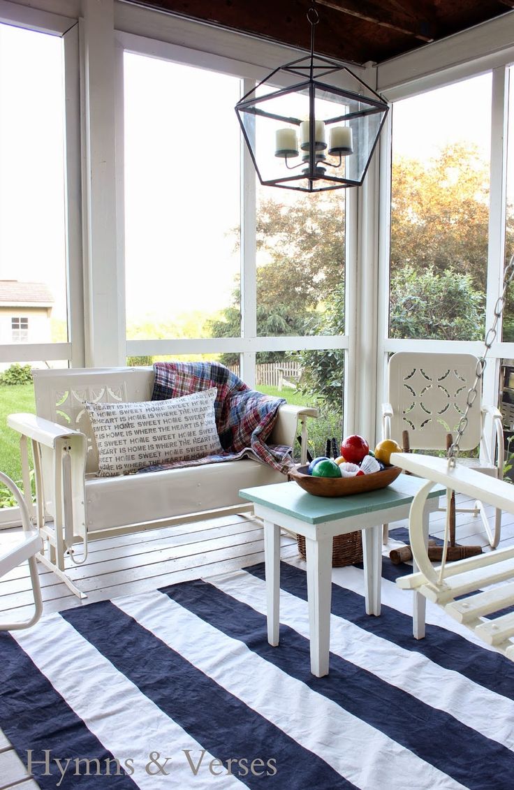 I love this porch: the rug, the lamp the vintage chairs, the table.. all so cute