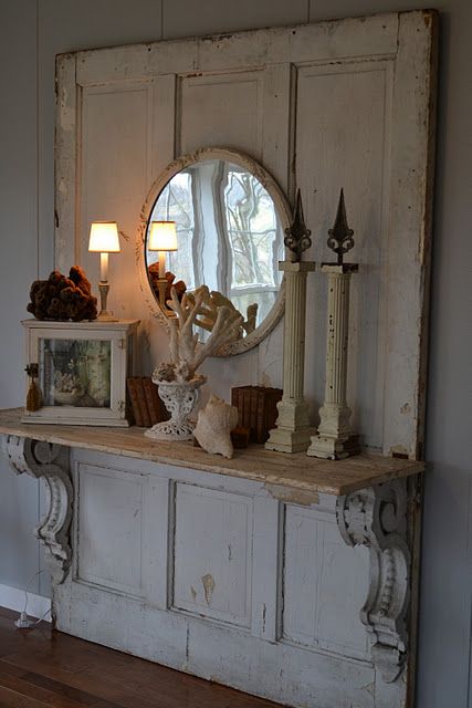 Old door with carved corbels and shelf creates a dramatic entry piece....(from T...