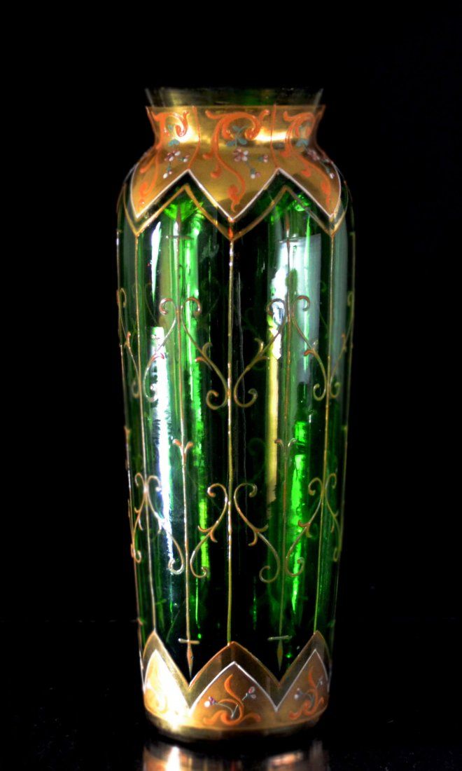 Vase of emerald green glass, bearing both gilded and enamel decorative patterns....