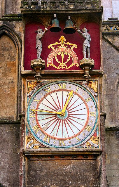 The clock on the exterior of Wells Cathedral. The latin motto 