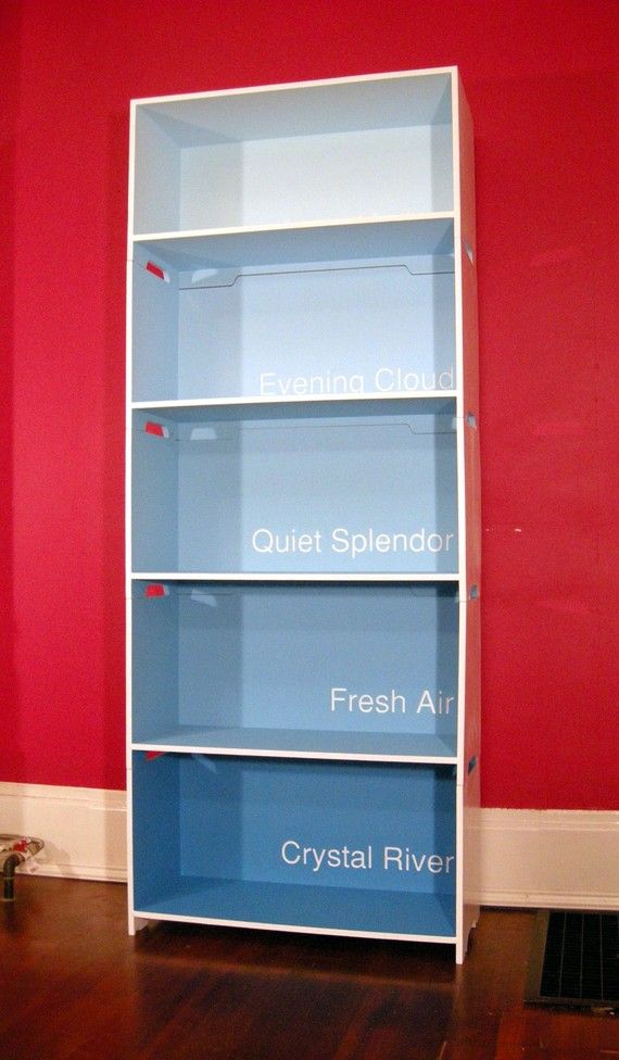 Cool idea. Ombre/paint chip bookcase.