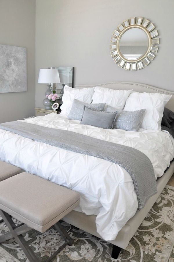 neutral bedroom, white bedding with neutral rug grey accents, abstract art