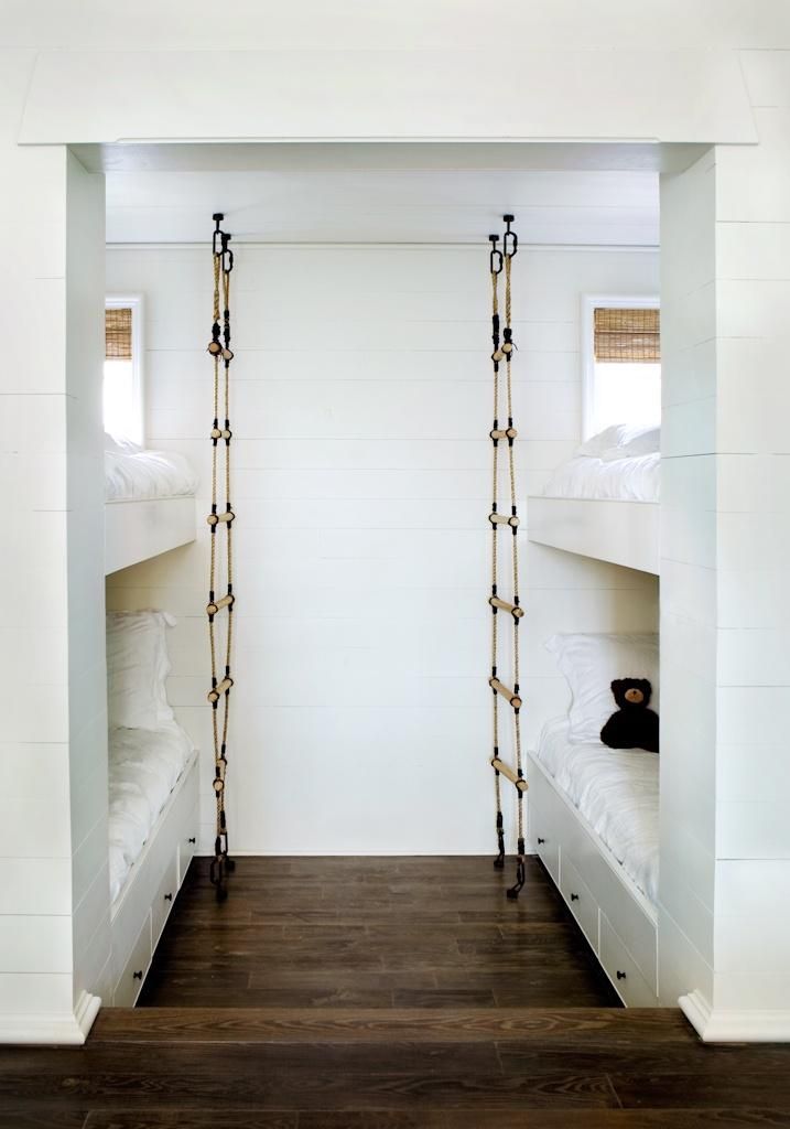 Rope ladders add pirate fun to a kids' bunk room decked out all in white, vi...