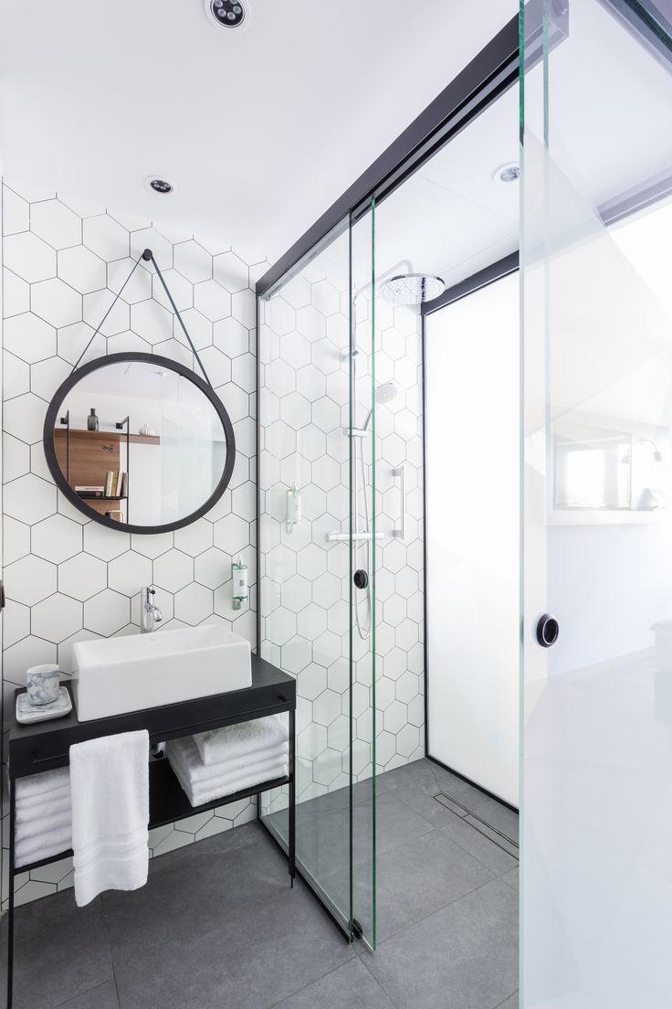 A honeycomb backsplash makes for a playfully modern space. #beautifulbathrooms #...