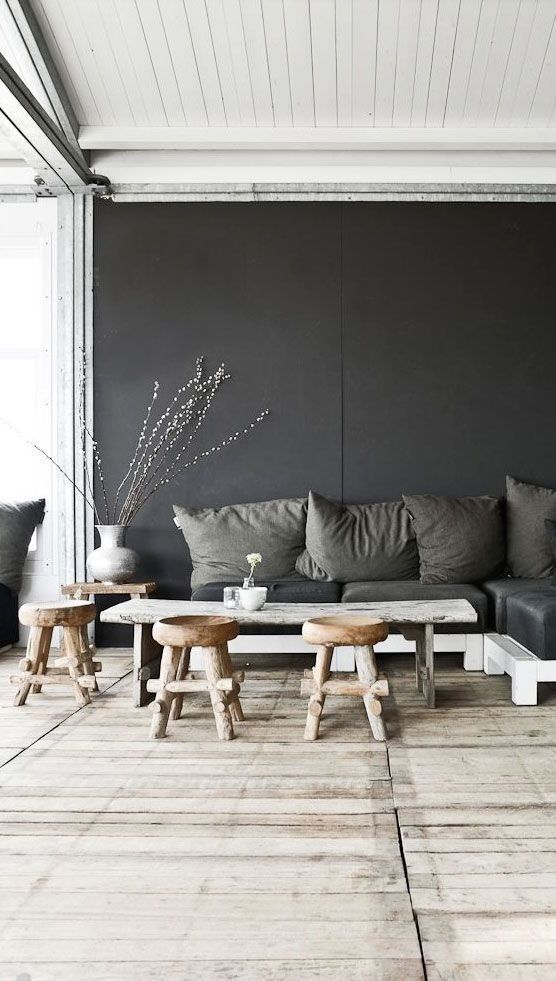 Grey wall, grey pillows, wooden table