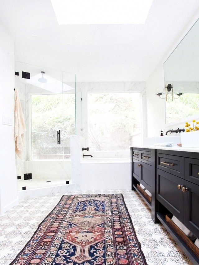 A vintage Persian rug is in a modern bathroom