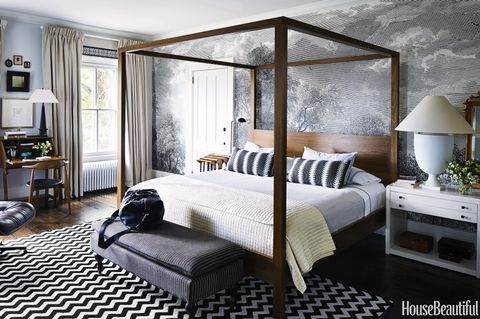 black and white bedroom with gray wallpaper and wood poster bed