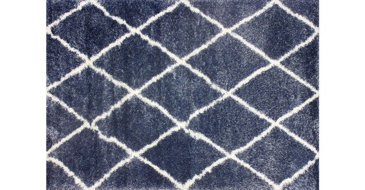 This richly textural polypropylene rug features a simple white lattice design on...