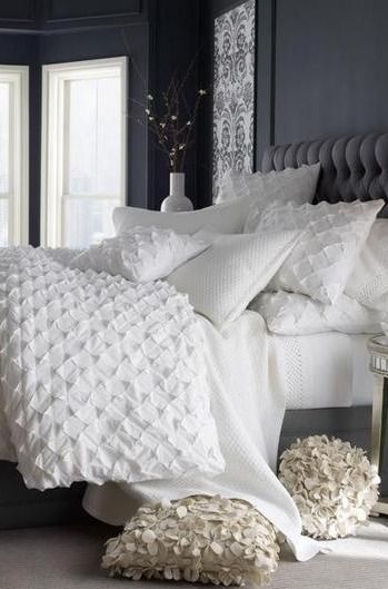 Add texture to an otherwise plain white bed with ruffled pillowcases and a pucke...
