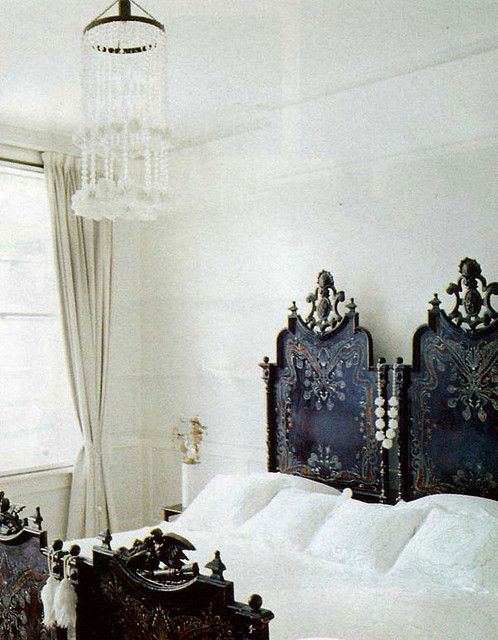 ornate antique twin headboards used together to create a king bed