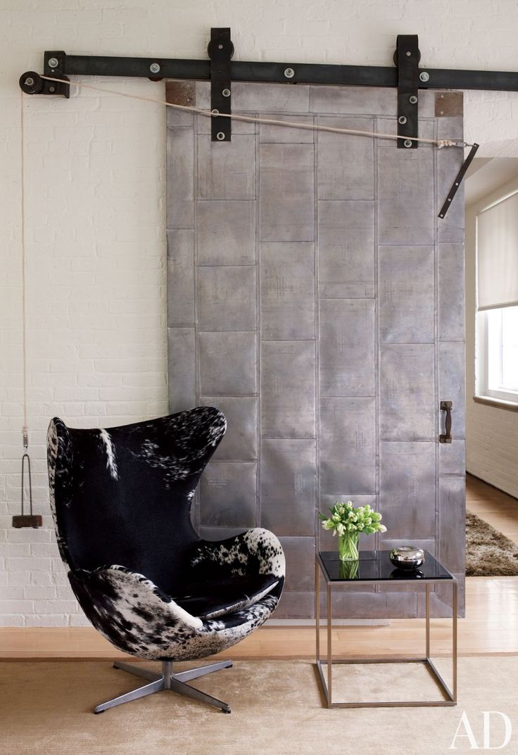 An industrial-chic Manhattan loft is outfitted with a black-and-white Jacobsen E...