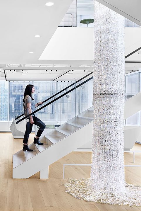 Cascading chains of crystals intermingled with strands of LEDs echo the flow of ...