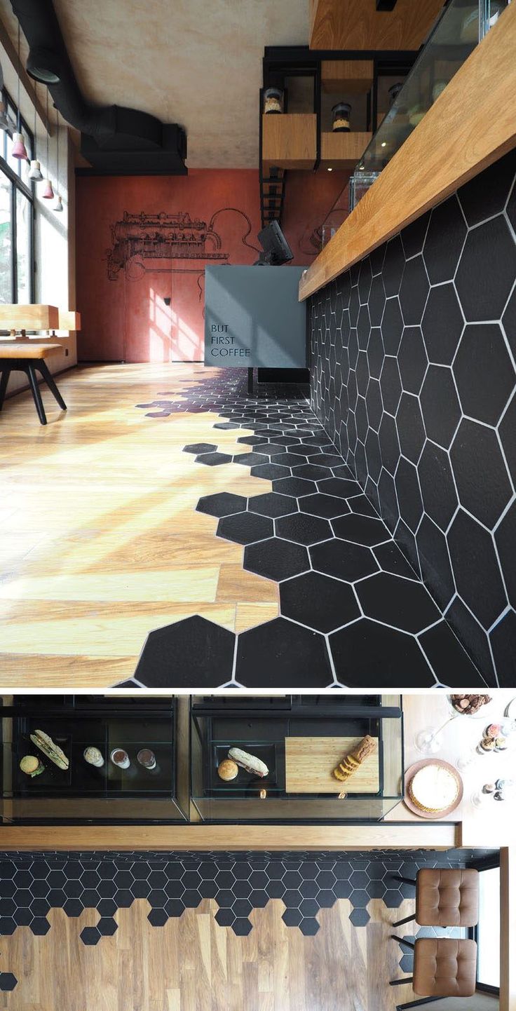 Black hexagon tiles and wood laminate flooring are a design element in this mode...