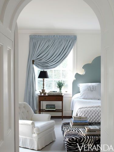 An elegant monogram adorns crisp white bedding in this bedroom by Suellen Gregor...